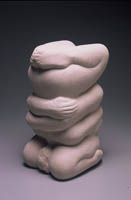 A sculpture of four hands holding each other.